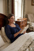 Woman wearing Barbara cotton long-sleeve nightgown in Navy, sizes AU 4-34, soft and comfortable for sleep and recovery.