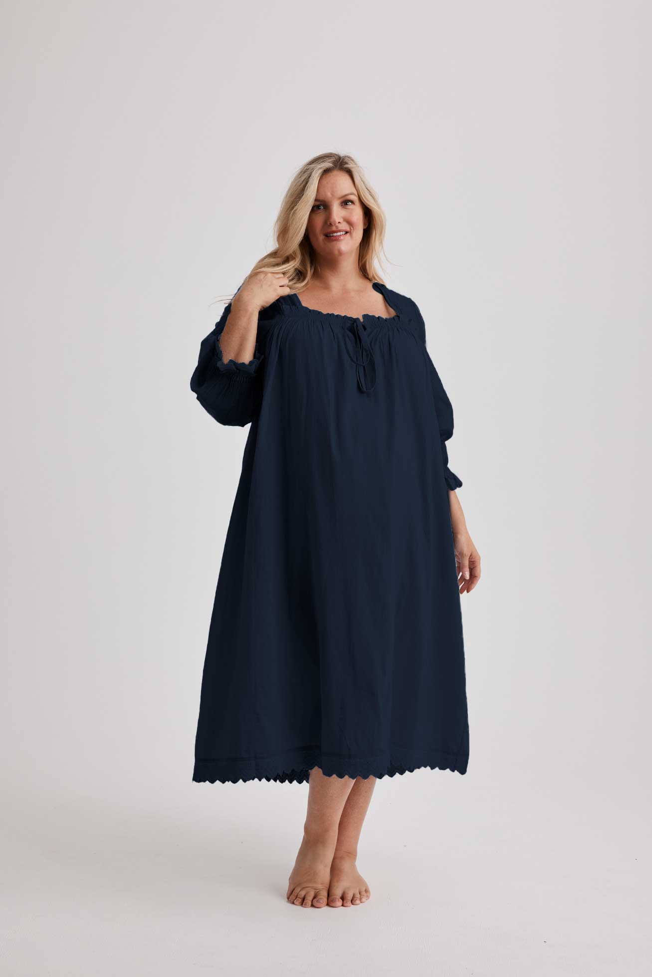 Woman wearing Barbara cotton long-sleeve nightgown in Navy, sizes AU 4-34, soft and comfortable for sleep and recovery.
