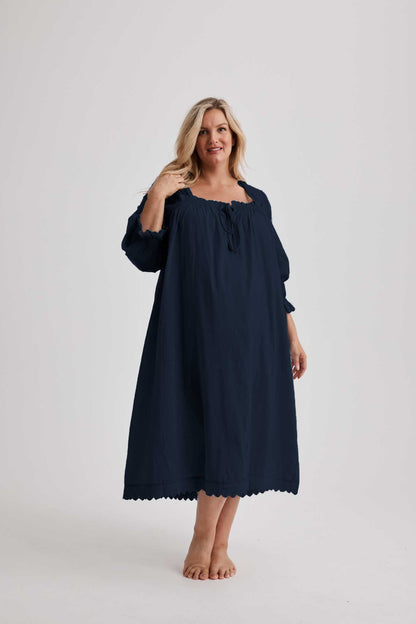 Woman wearing Barbara cotton long-sleeve nightgown in Navy, sizes AU 4-34, soft and comfortable for sleep and recovery.