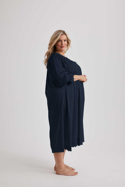 Woman wearing Barbara cotton long-sleeve nightgown in Navy, sizes AU 4-34, soft and comfortable for sleep and recovery.