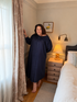 Harriet navy long sleeve cotton nightgown with smocked neckline and covered buttons, front view.